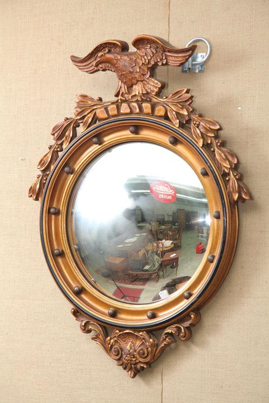 Appraisal: CONCAVE MIRROR Gilt frame with a carved eagle crest molded