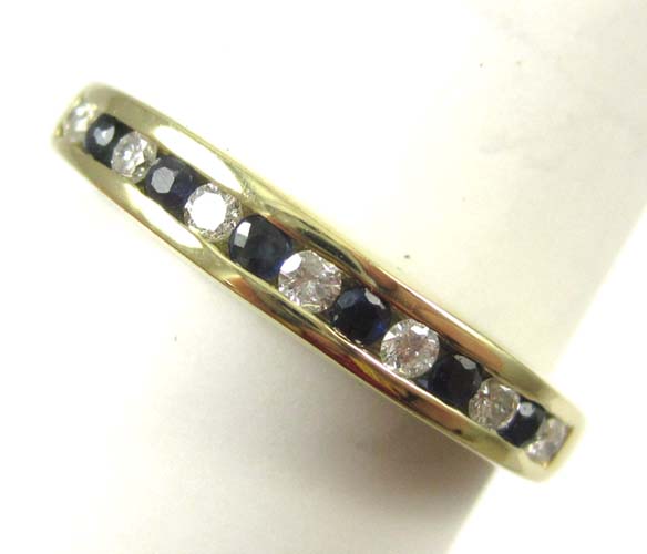 Appraisal: SAPPHIRE DIAMOND AND FOURTEEN KARAT GOLD RING with channel set