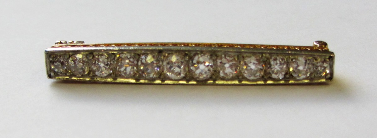 Appraisal: A diamond set brooch mounted with a row of twelve