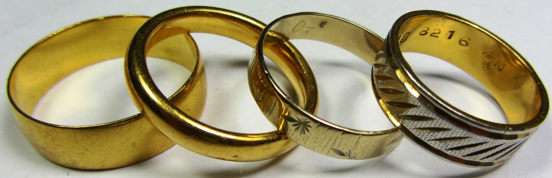 Appraisal: Two ct gold plain wedding rings and a ct gold