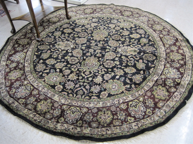 Appraisal: ROUND ORIENTAL CARPET Persian Kashan design of flowers on black