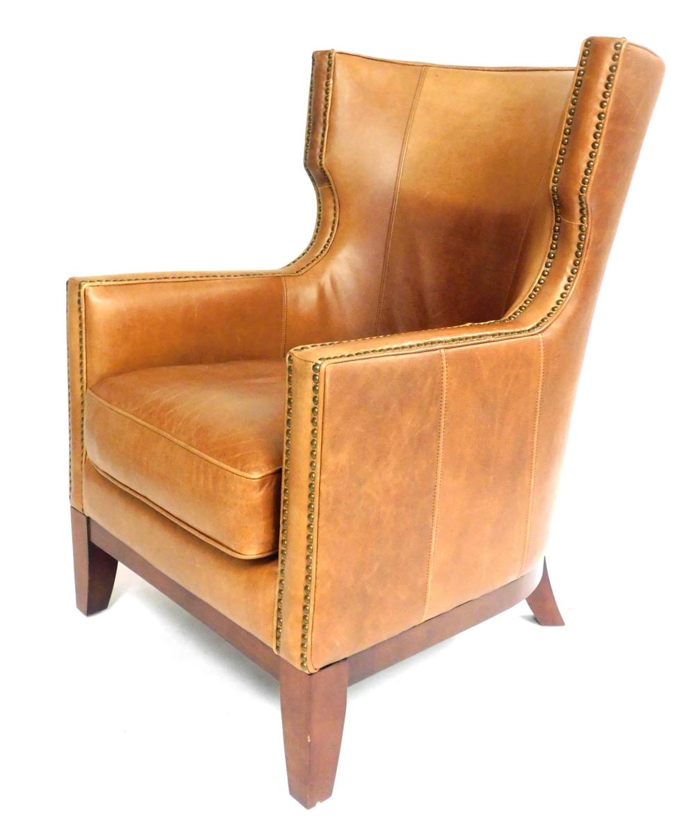 Appraisal: Camel colored leather wing back armchair th C brass nail