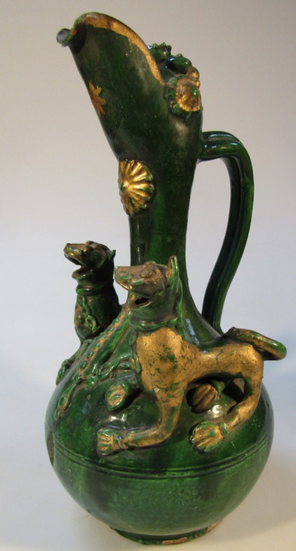 Appraisal: A Chinese pottery jug the bulbous body with shaped moulded