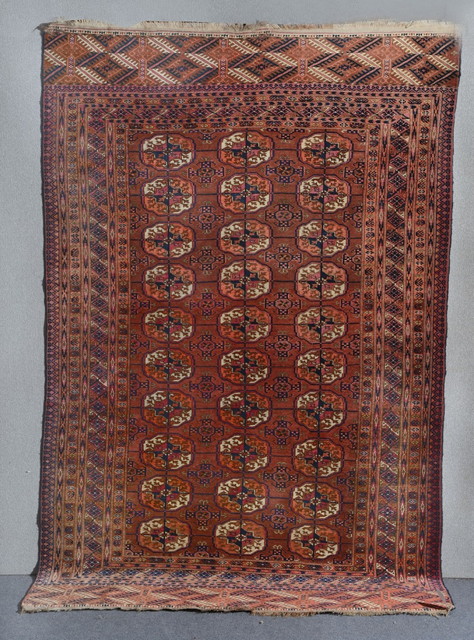 Appraisal: A TEKKE RED GROUND RUG decorated three rows of ten