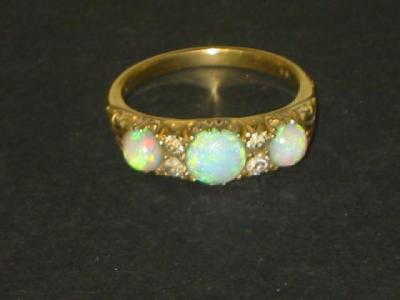 Appraisal: A VICTORIAN OPAL AND DIAMOND RING comprising three opals with