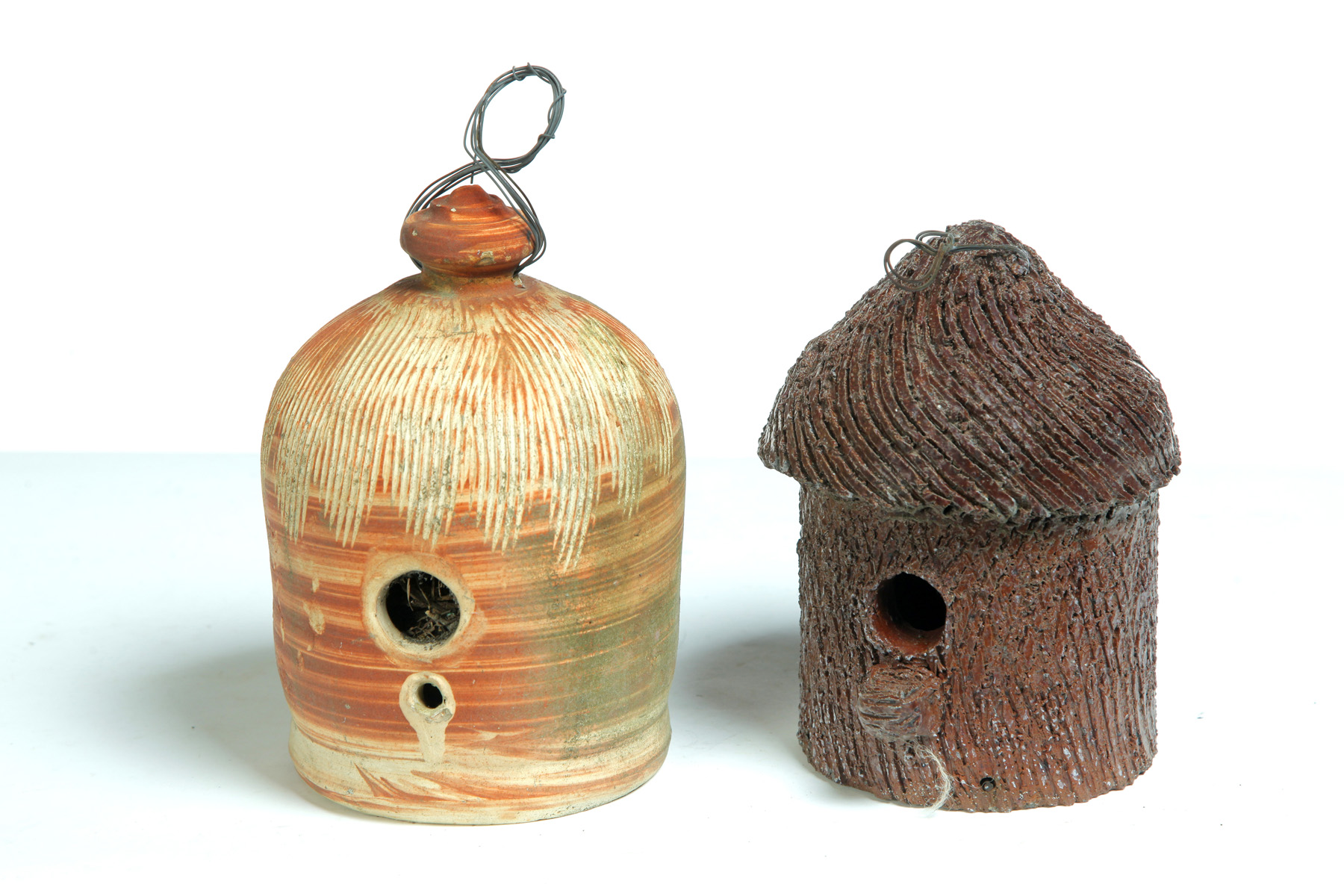 Appraisal: TWO AMERICAN POTTERY BIRDHOUSES Twentieth century Unglazed yellowware h Ex