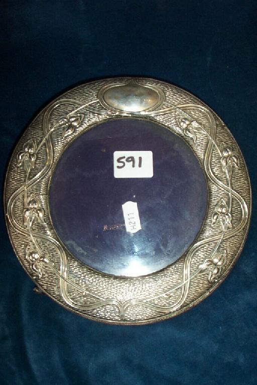 Appraisal: A silver photograph frame of circular form with engine turned