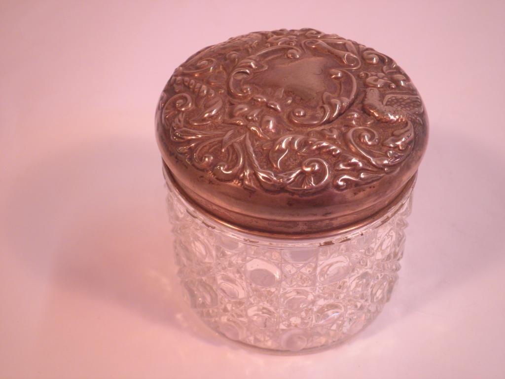 Appraisal: A silver mounted dressing table jar embossed with birds scrolls