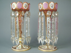 Appraisal: Pair of cranberry glass table lustres on knopped pentagonal stems