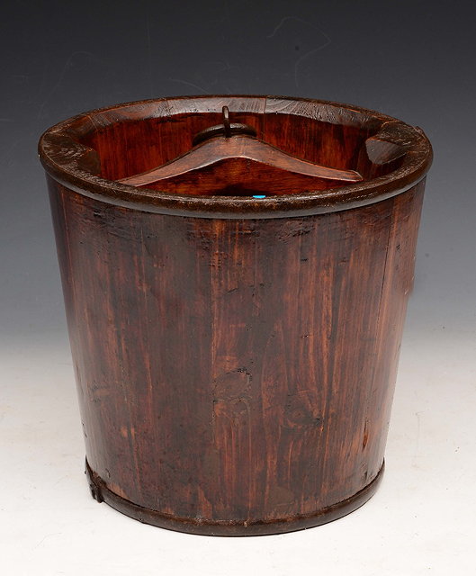 Appraisal: A COOPERED DAIRYMAID BUCKET with iron ring and tapering sides