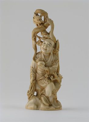 Appraisal: A large Japanese ivory carving of a seated figure holding