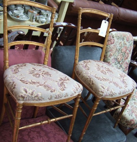 Appraisal: A pair of th century gilt framed bedroom chairs with