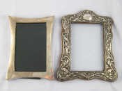 Appraisal: Two silver photo frames one silver faced shaped oak back