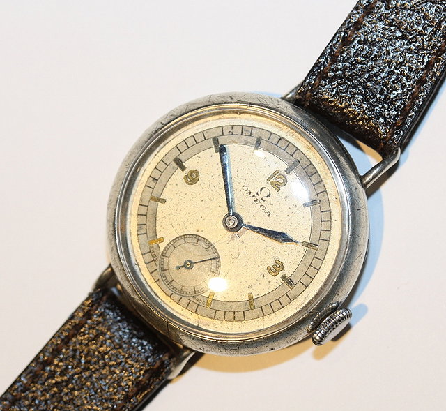 Appraisal: A SILVER CASED OMEGA TRENCH WATCH with cream dial Arabic