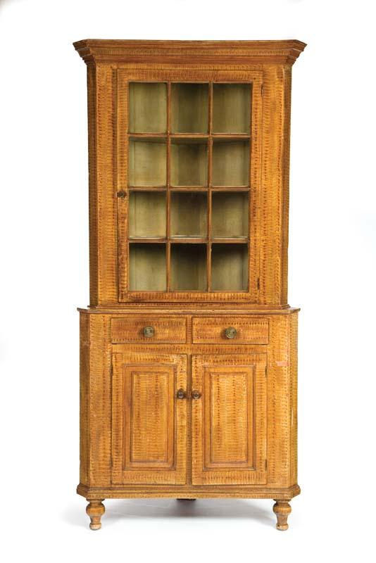 Appraisal: DECORATED CORNER CUPBOARD Pennsylvania th century poplar and pine Two-piece