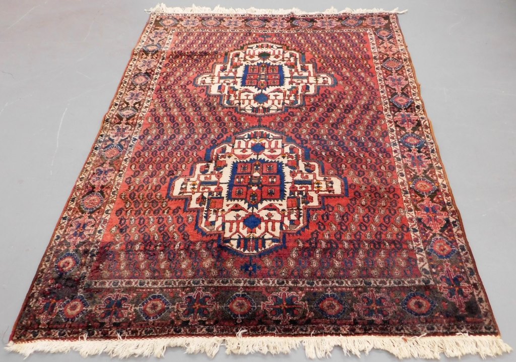 Appraisal: PERSIAN GEOMETRIC BURGUNDY RUG Middle East th Century Two red