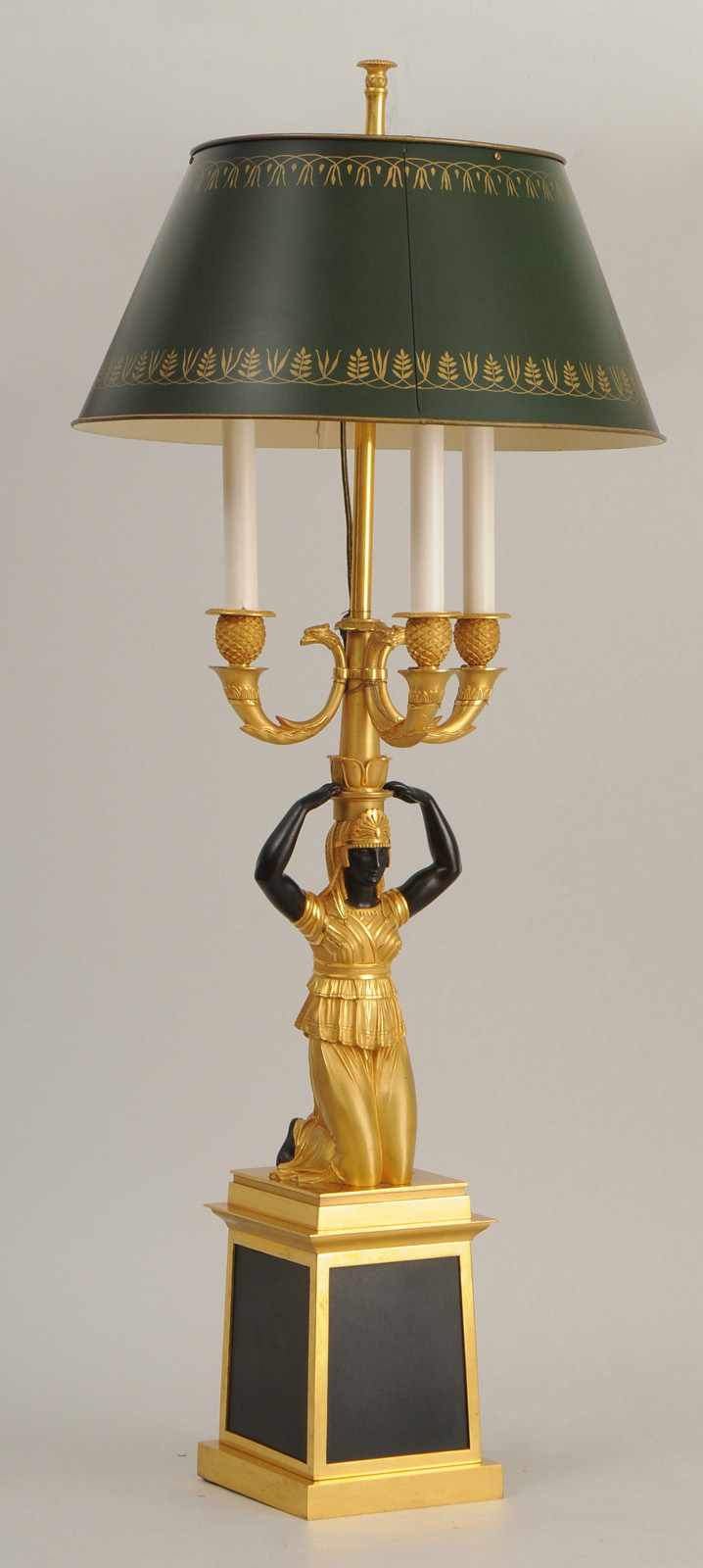 Appraisal: EMPIRE STYLE PATINATED AND GILT-METAL THREE-LIGHT LAMP Modeled as a