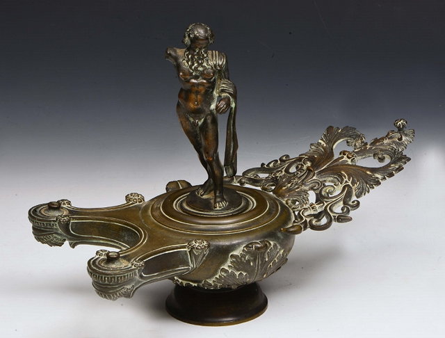 Appraisal: A GRAND TOUR STYLE BRONZE OIL LAMP with acanthus foliate