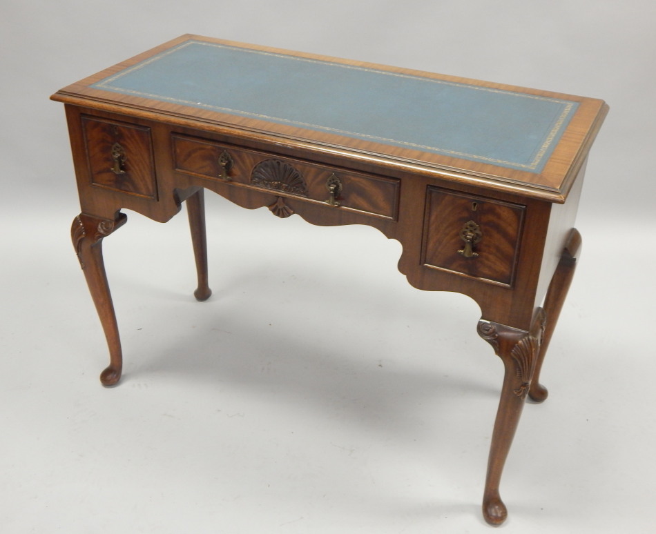 Appraisal: A mahogany writing table the rectangular top with a blue