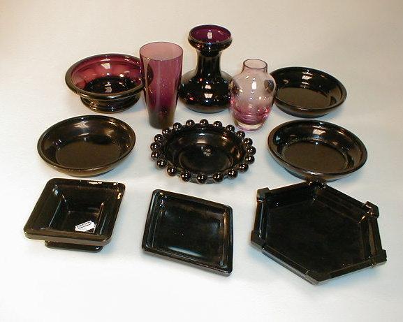 Appraisal: A quantity of dark glass stands amethyst glass items including