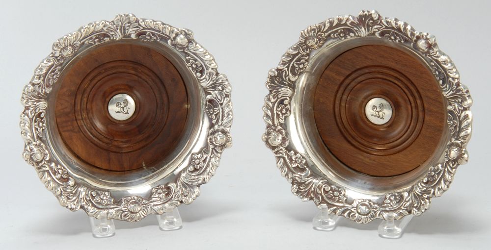 Appraisal: PAIR OF ENGLISH SILVER PLATED WINE COASTERS With foliate borders