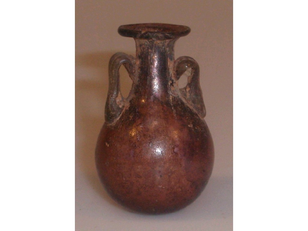 Appraisal: A small purple glass amphoriskos the flaring mouth with an