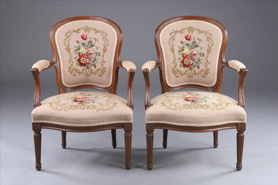 Appraisal: PAIR ROCOCO REVIVAL WALNUT NEEDLEWORK-UPHOLSTERED ARMCHAIRS th century Finger-molded frames