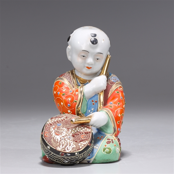 Appraisal: Japanese Satsuma-type Kutani porcelain seated child playing drum some losses