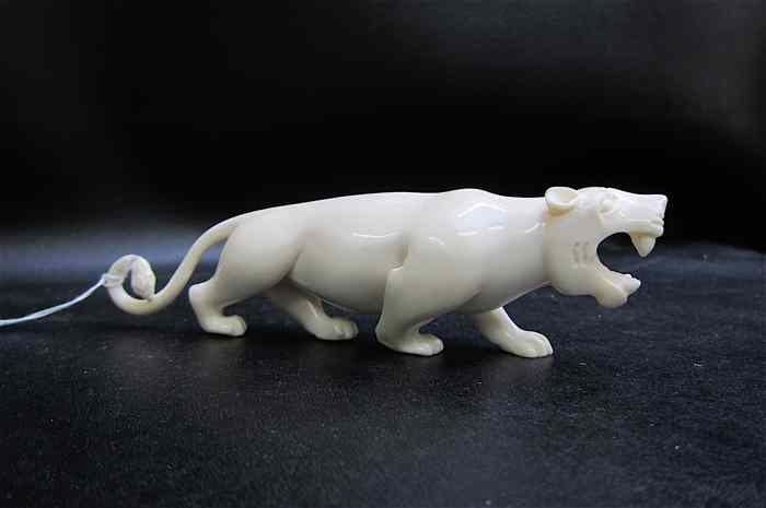 Appraisal: AFRICAN CARVED IVORY LIONESS open-mouthed in attack pose Dimensions ''L