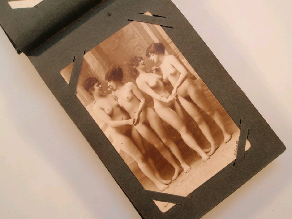 Appraisal: An album containing twenty one photographic postcards of female nudes