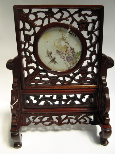 Appraisal: A MINIATURE CHINESE TABLE SCREEN The rosewood and mahogany pierced-carved