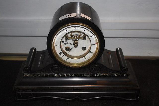 Appraisal: A VICTORIAN BLACK SLATE MANTEL CLOCK with drum dial and