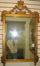 Appraisal: AN AMERICAN WALL MIRROR having a carved floral decorated frame