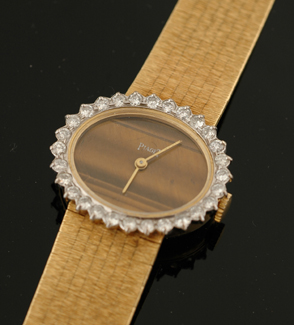 Appraisal: A Ladies Piaget diamond wristwatch Manual oval tigers eye dial