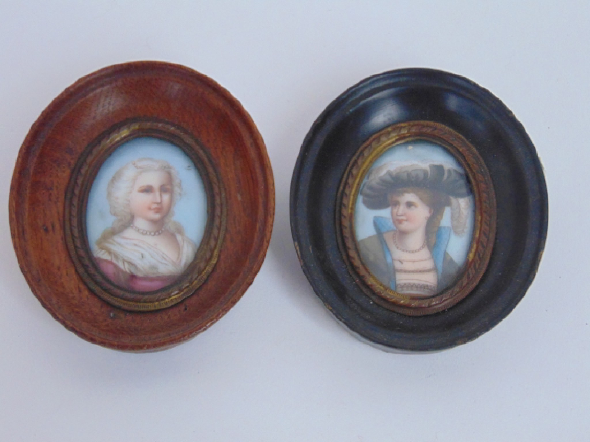 Appraisal: Two late th century oval miniature portraits on ceramic panels