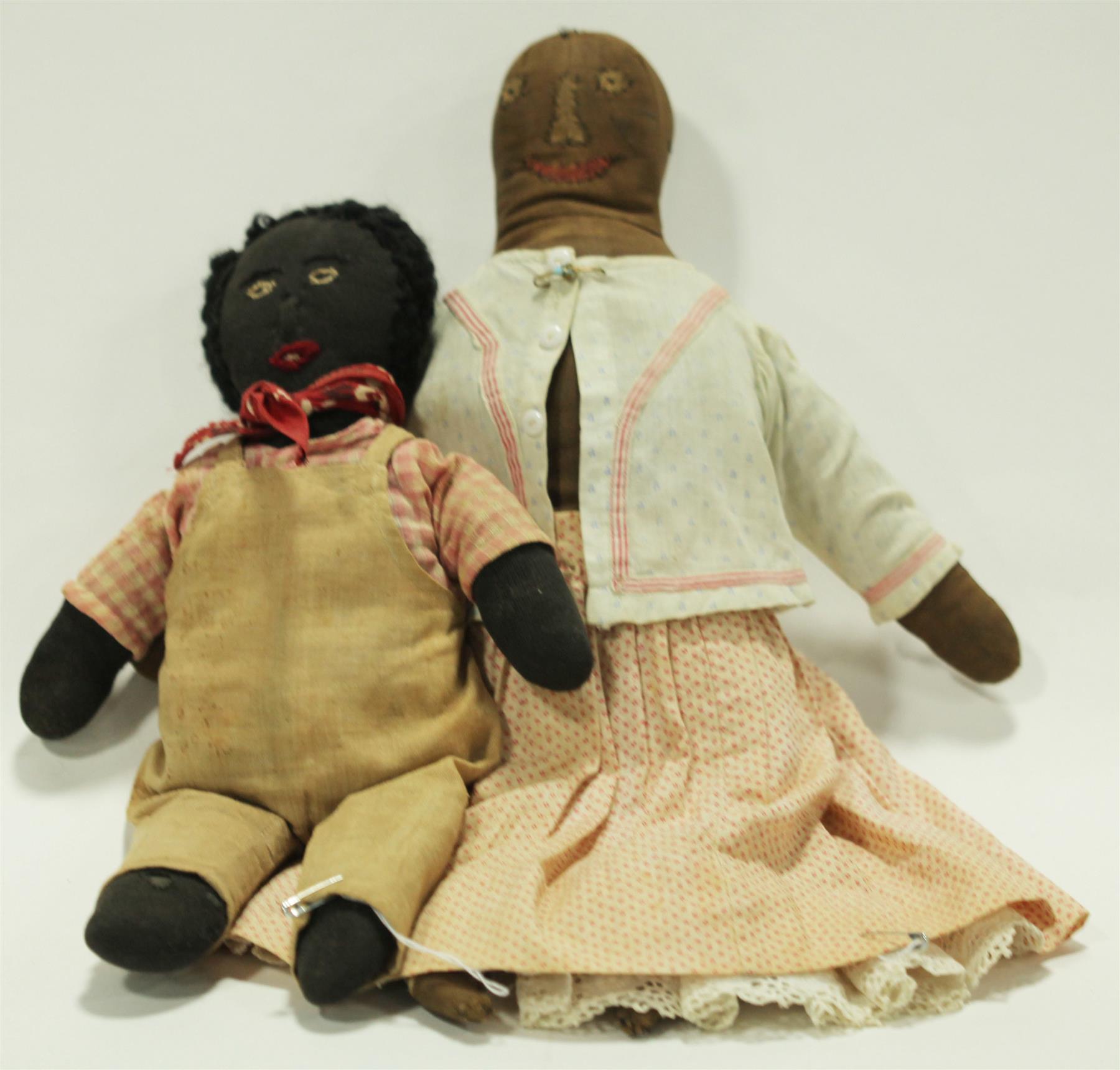 Appraisal: TWO EARLY BLACK CLOTH DOLLS Nineteenth century dolls with stitched