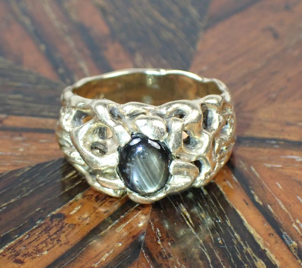 Appraisal: MAN'S BLACK STAR SAPPHIRE AND FOURTEEN KARAT GOLD RING The