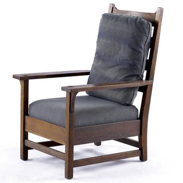 Appraisal: GUSTAV STICKLEY Oversized high-back armchair with four horizontal slats U-shaped