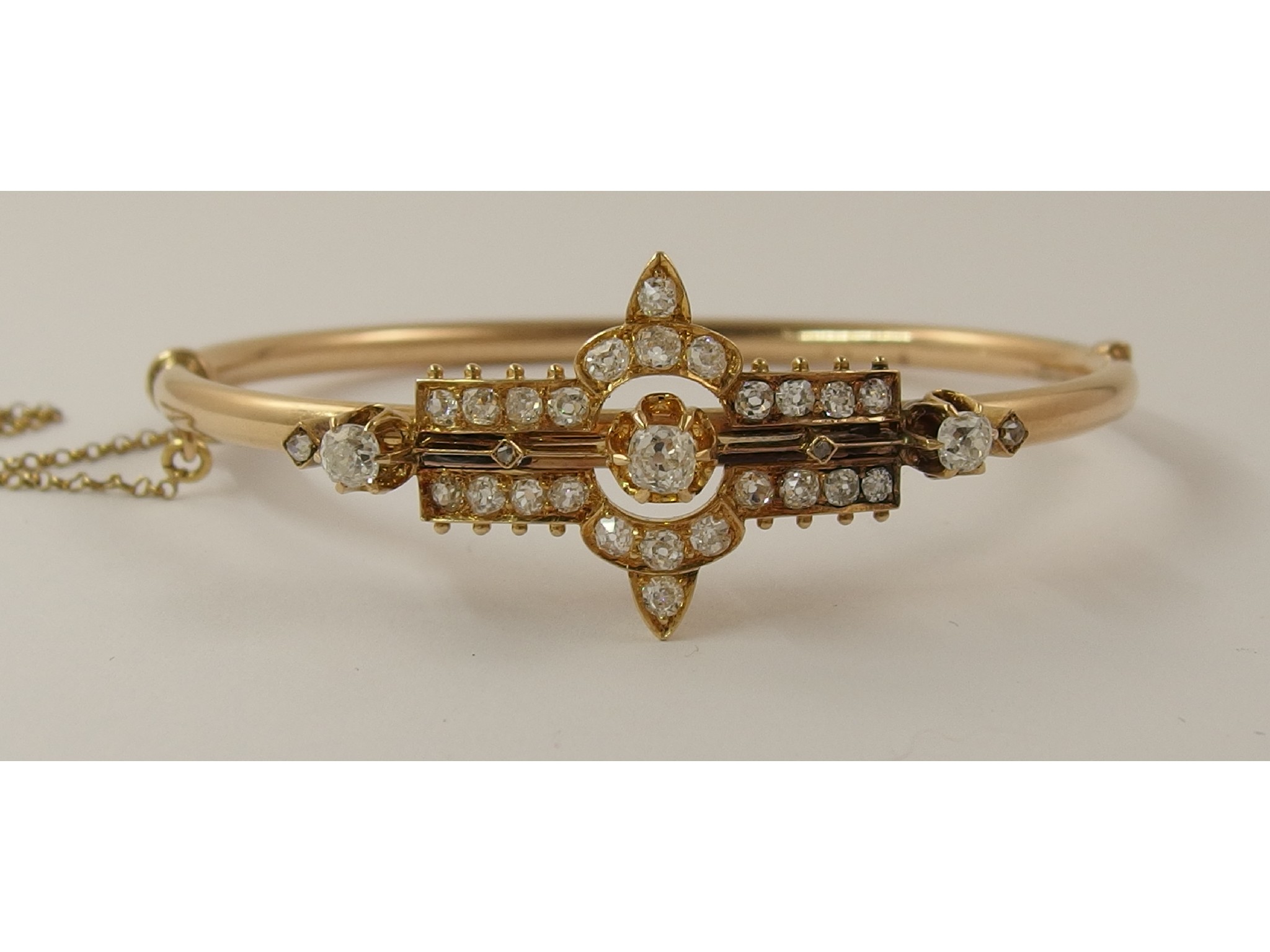 Appraisal: A diamond set banglethe rose coloured metal oval tubular bangle