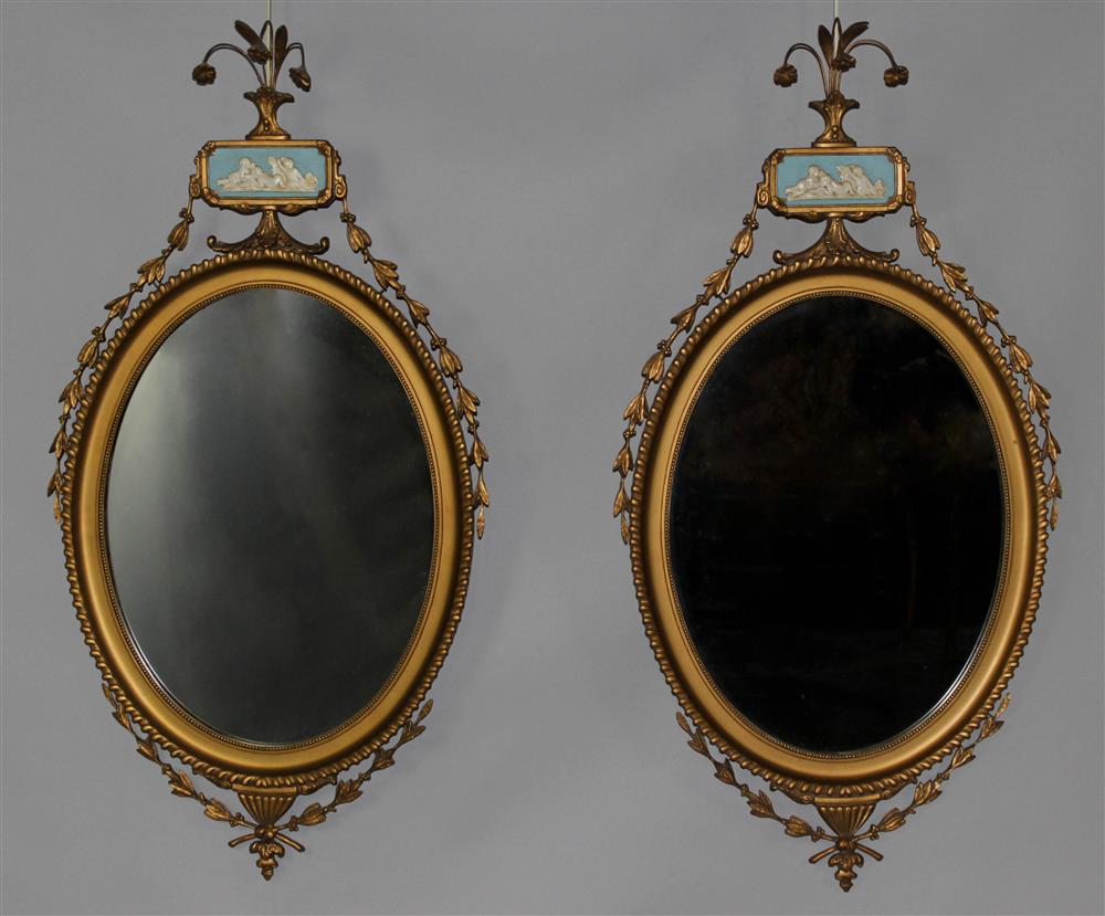 Appraisal: PAIR OF ADAM STYLE GILTWOOD AND GESSO OVAL MIRRORS WITH