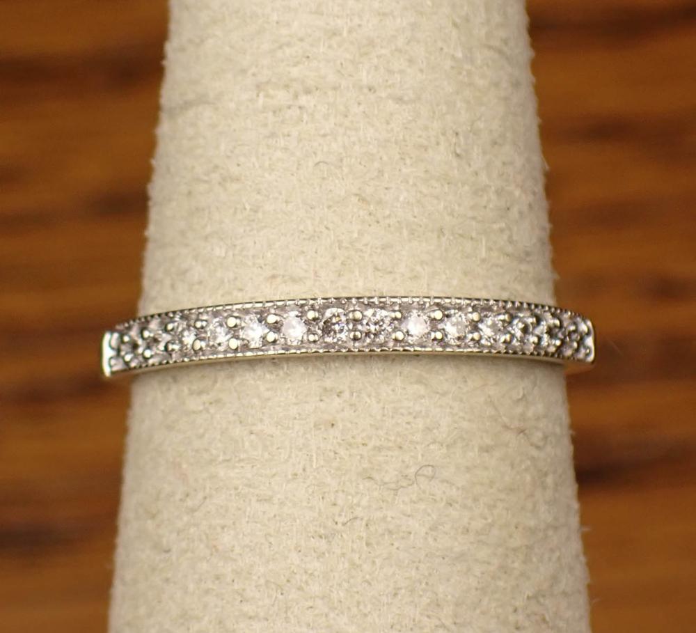 Appraisal: DIAMOND AND FOURTEEN KARAT GOLD WEDDING BAND The K white