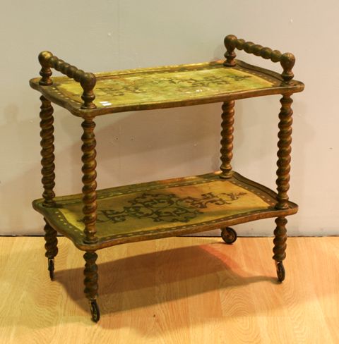 Appraisal: A Venetian style two tier giltwood tea trolley with carved