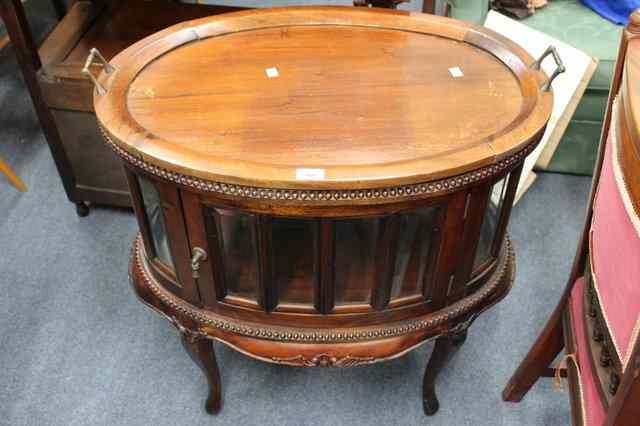 Appraisal: AN ORIENTAL HARD WOOD DRINKS CABINET the oval tray top