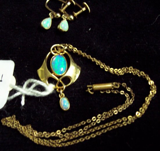 Appraisal: An opal pendant in a gold kite shaped setting with