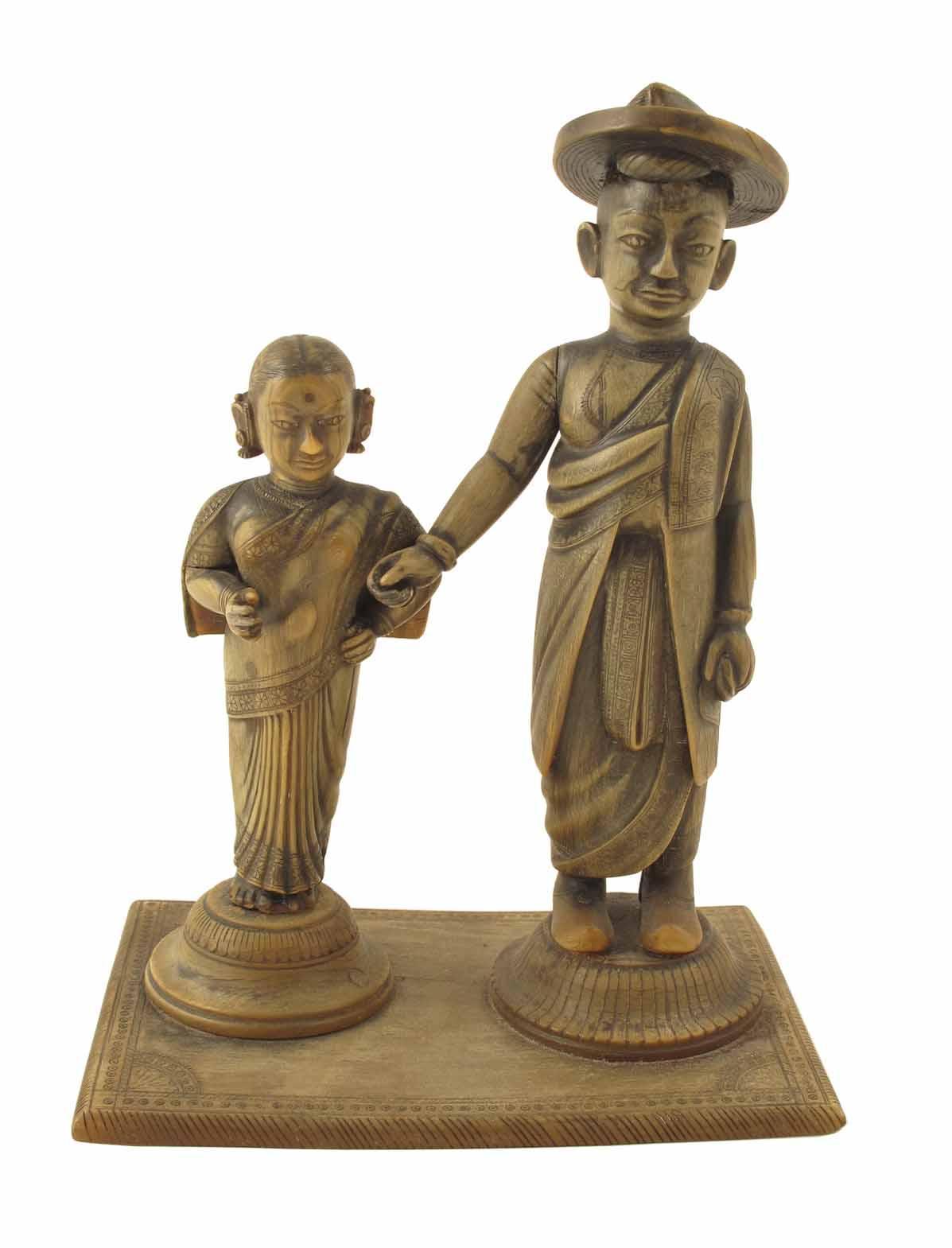 Appraisal: An Indian horn carving of a Hindu merchant and his