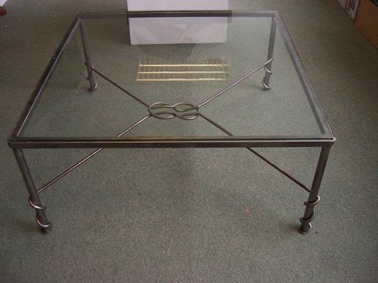 Appraisal: A square glass top table on a wrought iron support