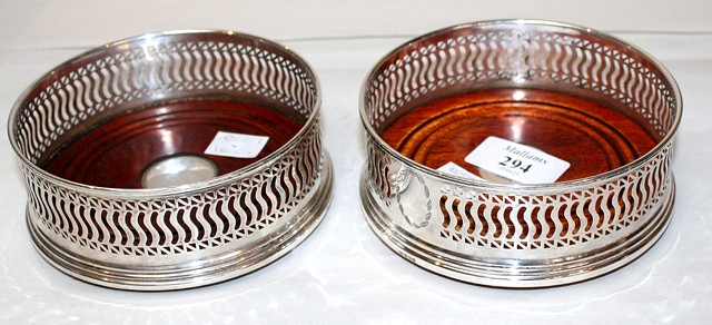 Appraisal: A PAIR OF MODERN SILVER WINE COASTERS with pierced sides