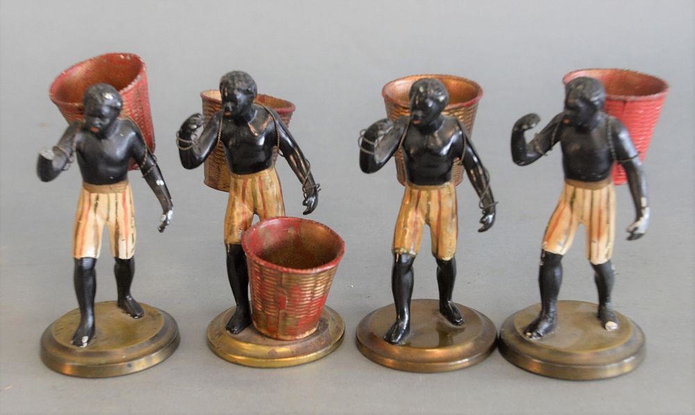 Appraisal: Four Blackamoor Figures carrying baskets to be toothpick holders one