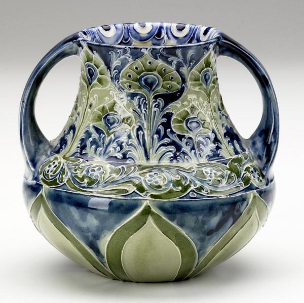 Appraisal: MOORCROFTTwo-handled Florian vase with peacock feathersW Moorcroft DES signature and