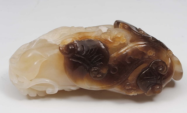 Appraisal: A Chinese white and brown jade ling chih th Centurycarved